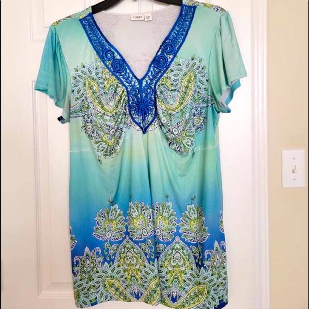 Teal green shirt with paisley design.